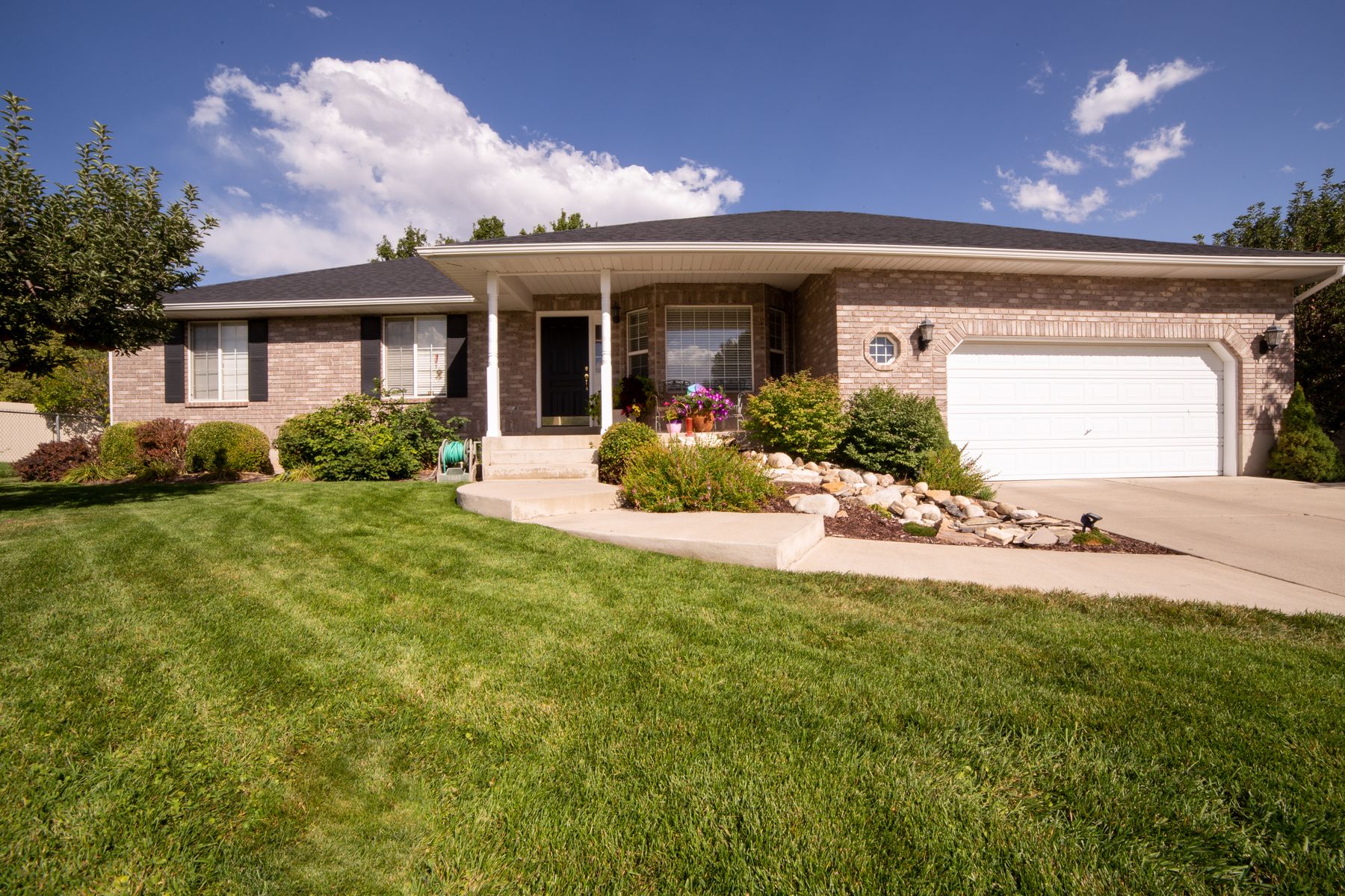 Welcoming home with a green lawn and front porch